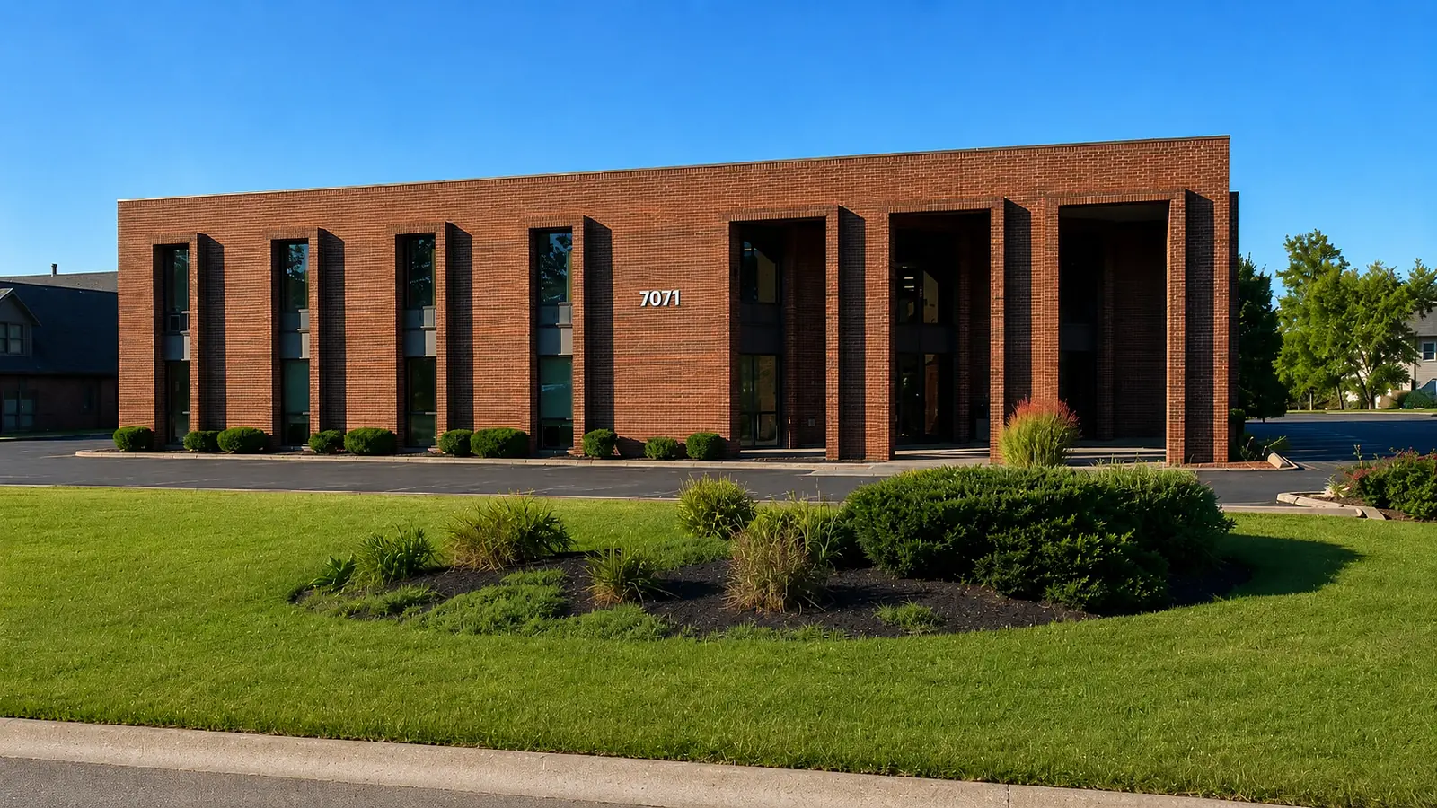 The Pirnia Law Office building exterior — a red-brick building at 7071 Corporate Way, Dayton, Ohio.
